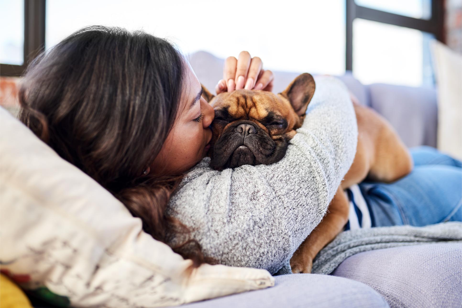 woman cuddling dog.